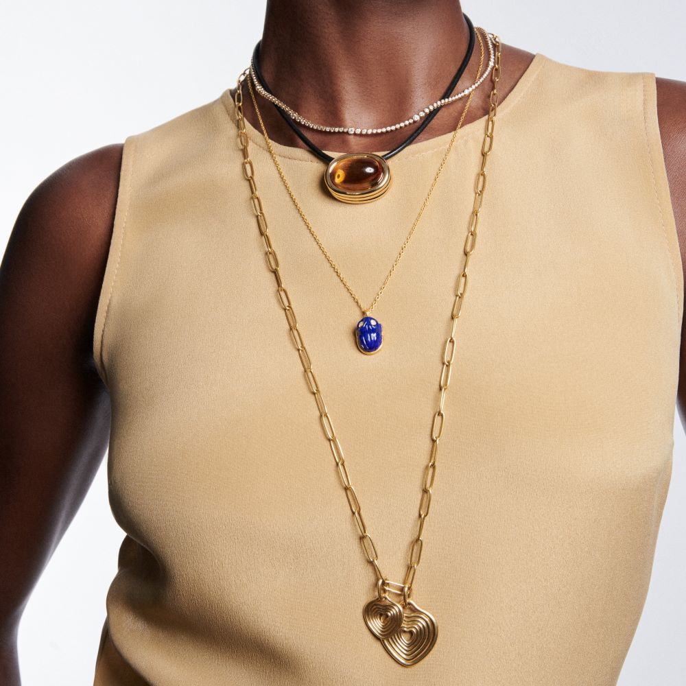 A woman wearing a tan top and an Ondyn Rainsun Necklace.