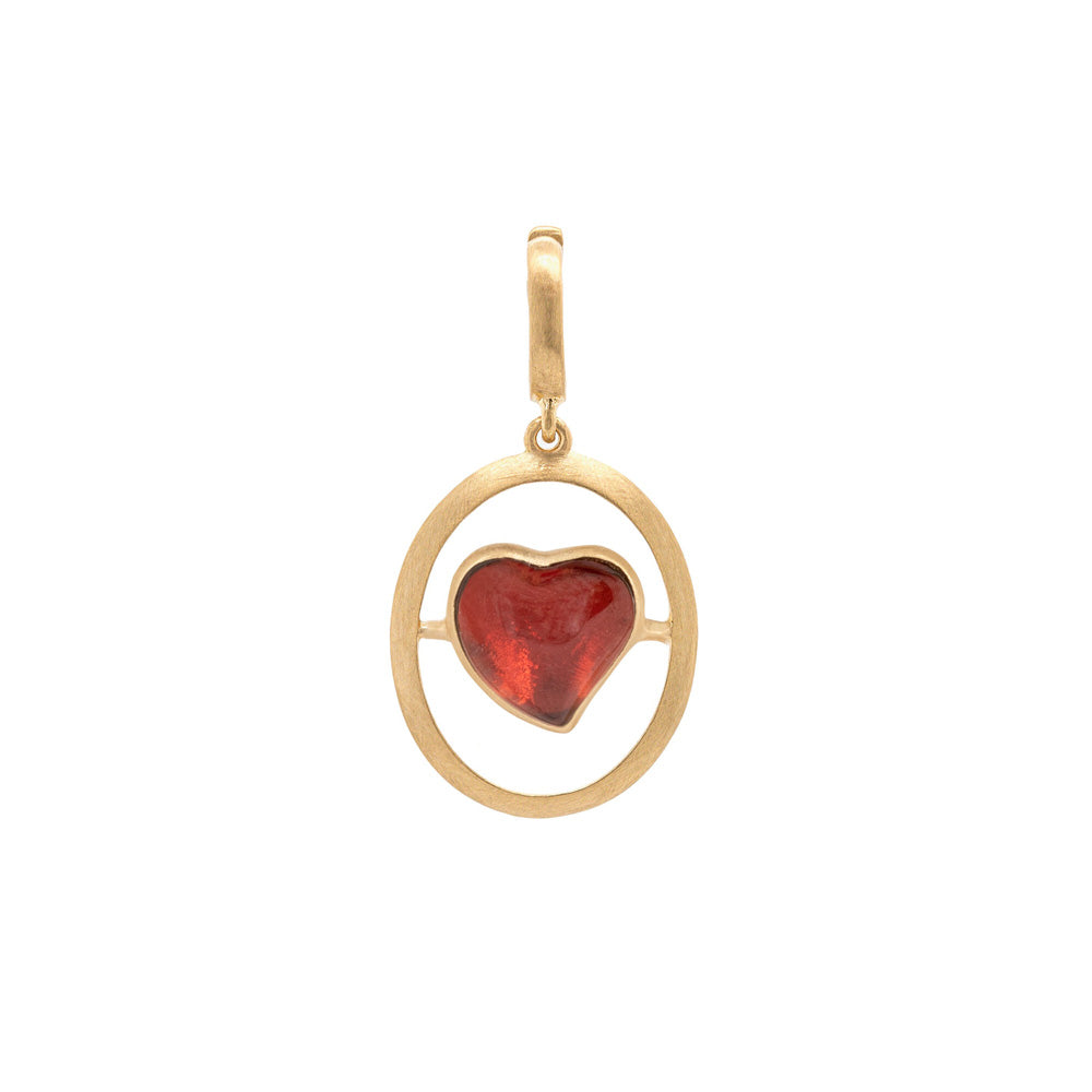 An Annoushka Love Heart Charm pendant with a red garnet stone on a yellow gold chain.