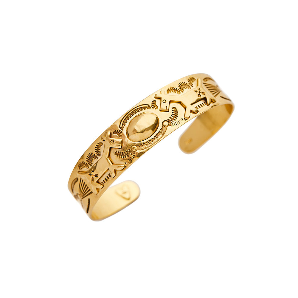 A Christina Alexiou Animal Cuff bracelet with a hammered yellow gold and etched animal design.
