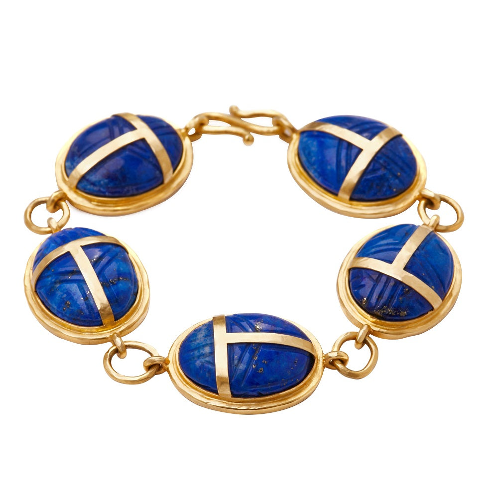 A Scarab Lapis Bracelet by Christina Alexiou, a 14k yellow gold-plated bracelet with lapis stones.