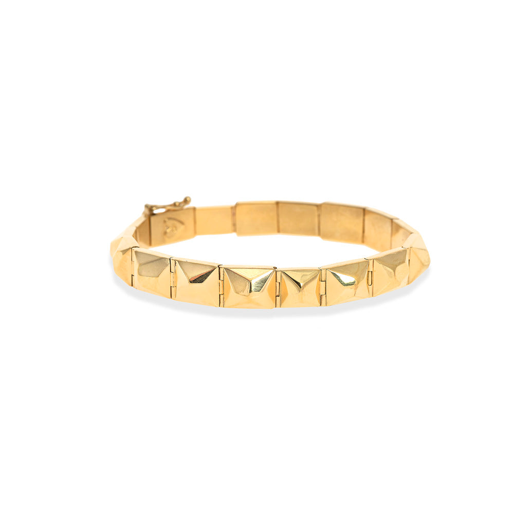 A Christina Alexiou Pyramid Bracelet with squares on it.