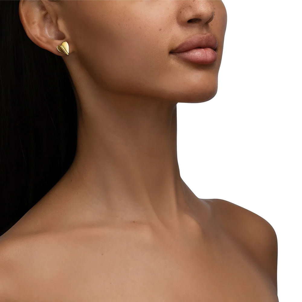 The model is wearing a pair of Cadar's Wings of Love 18k yellow gold stud earrings.
