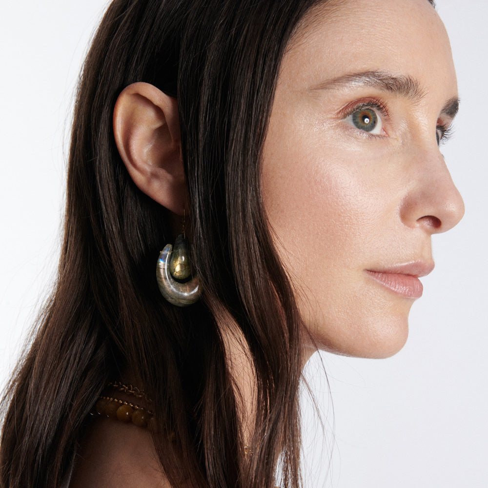 A woman with long hair wearing a pair of Ten Thousand Things O'Keefe Earrings.