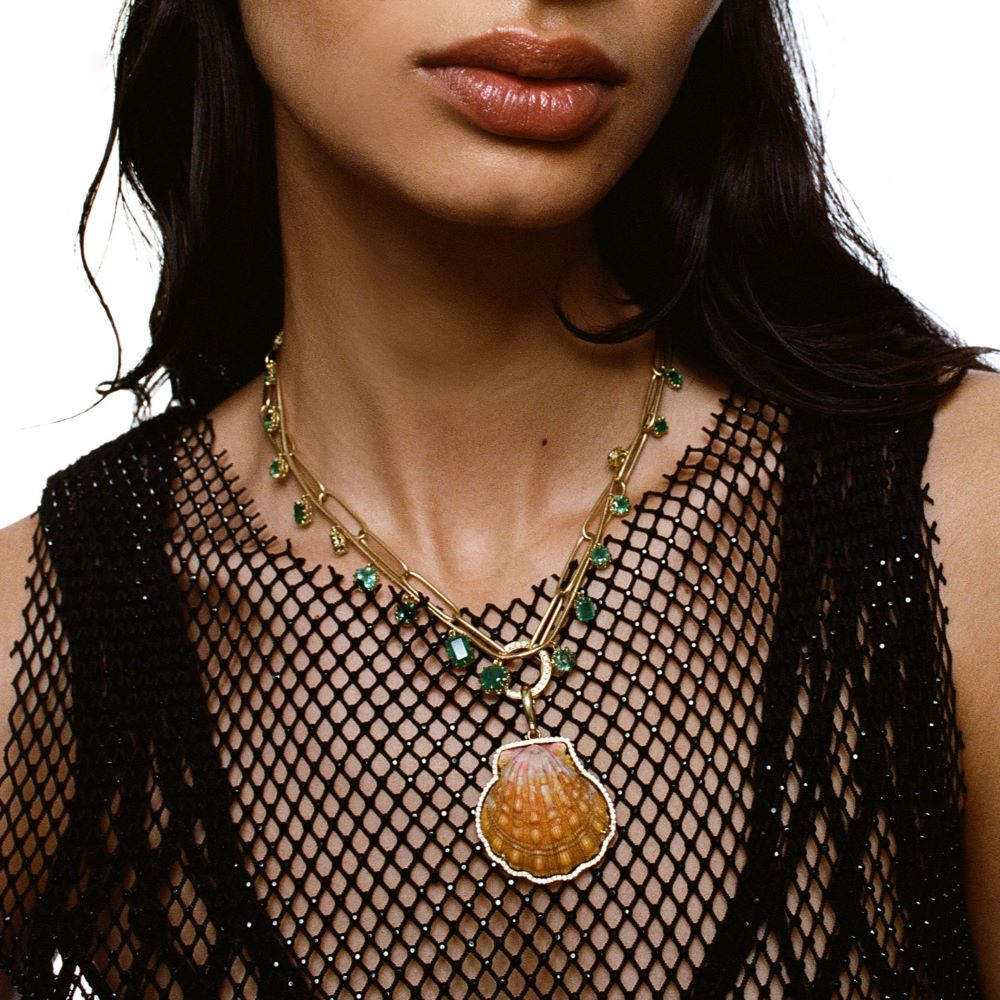 A woman wearing a Jenna Blake Fringe Necklace Emerald on a rope chain.
