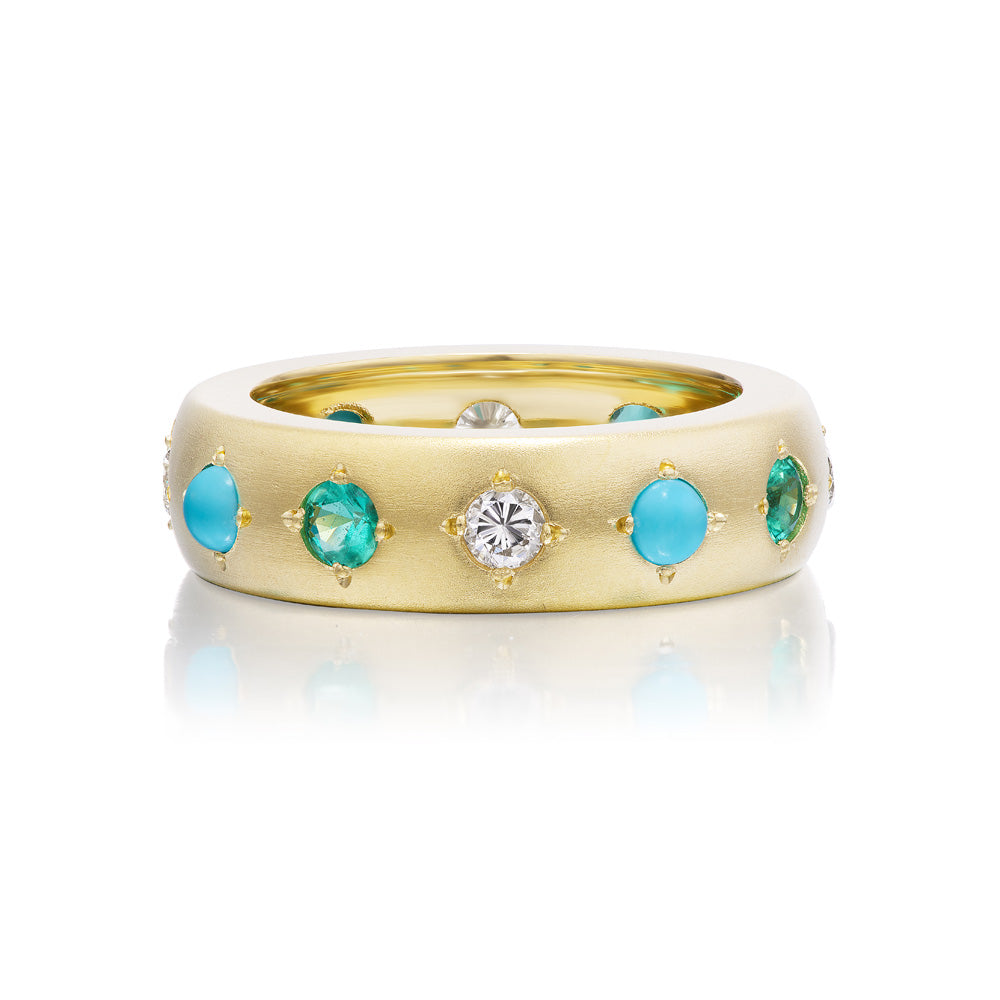 A solid yellow gold Gypsy Ring band with inlaid circle cut turquoise stones and diamonds by Jenna Blake.