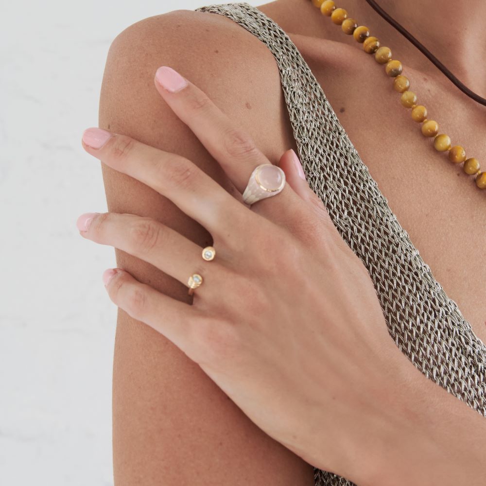 A woman wearing a KWIT Orb Ring with a yellow gold setting.