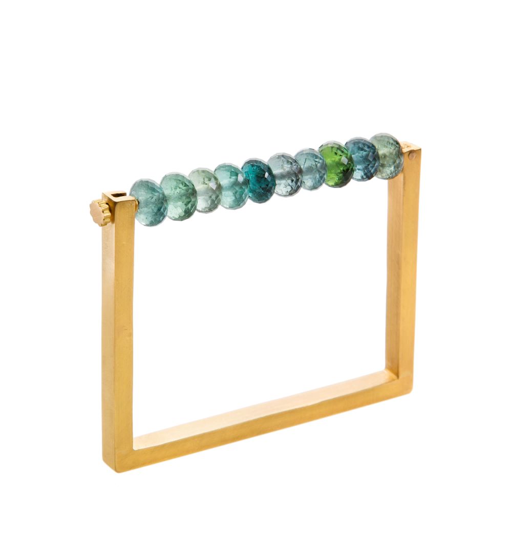 A Munnu yellow gold bracelet with Square Tourmaline beads.