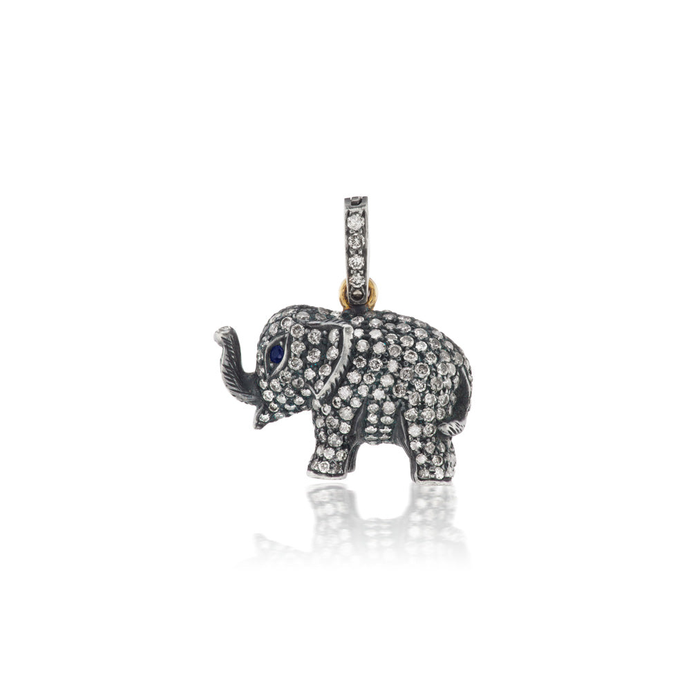 A Munnu Diamond Elephant Charm with blue sapphire eyes.