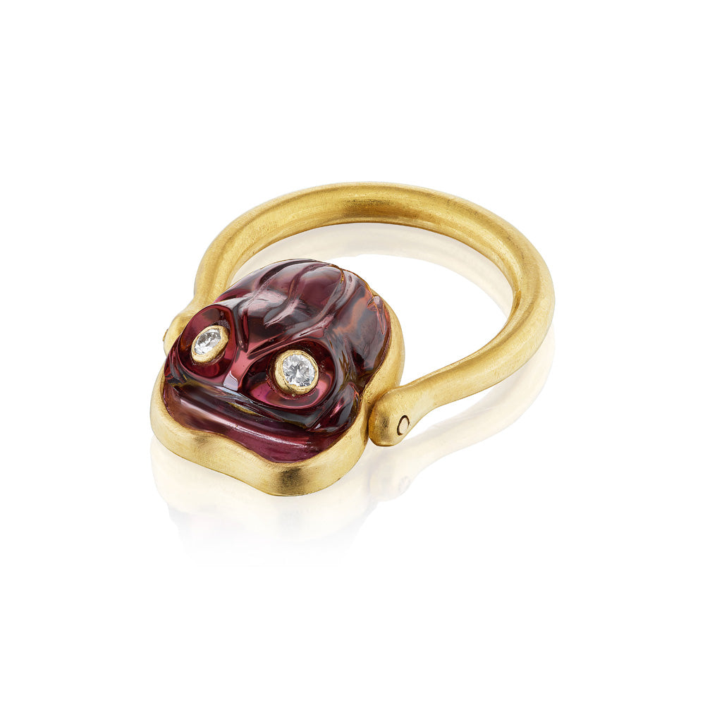 A hand-carved Frog Ring adorned with a red stone and diamonds, made by Munnu.