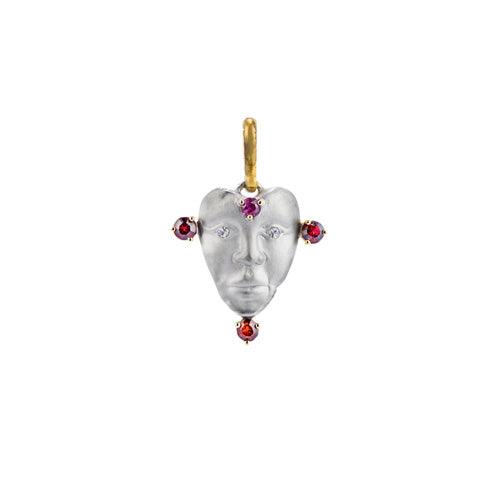 A NGHI pendant featuring a woman's face adorned with upcycled rubies, designed as a love charm to support charity:water.
