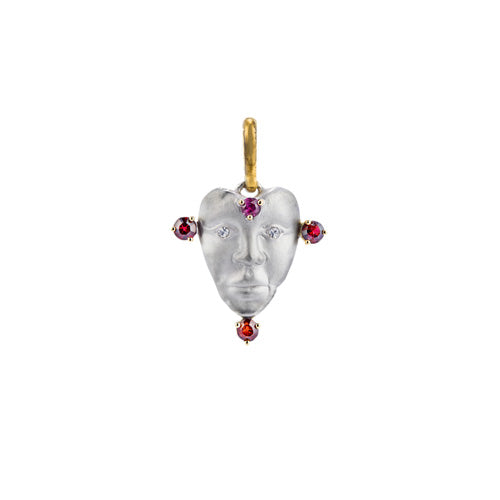 A NGHI pendant featuring a woman's face adorned with upcycled rubies, designed as a love charm to support charity:water.