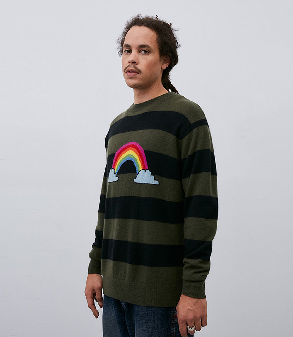A man wearing a Leret Leret crewneck sweater made of Mongolian cashmere, featuring a vibrant rainbow design on it.