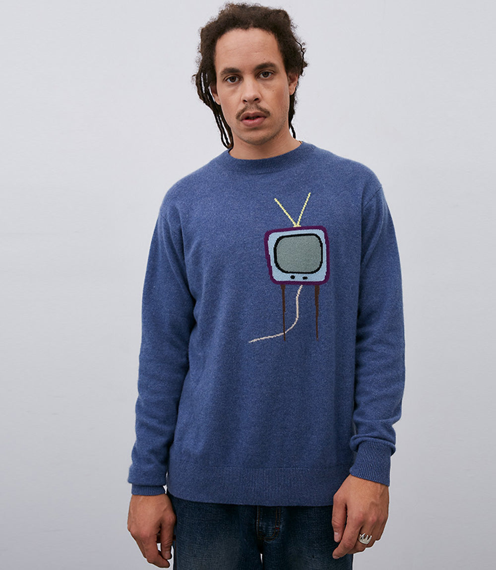 A man wearing a blue No. 61 TV Sweater with Leret Leret logo.
