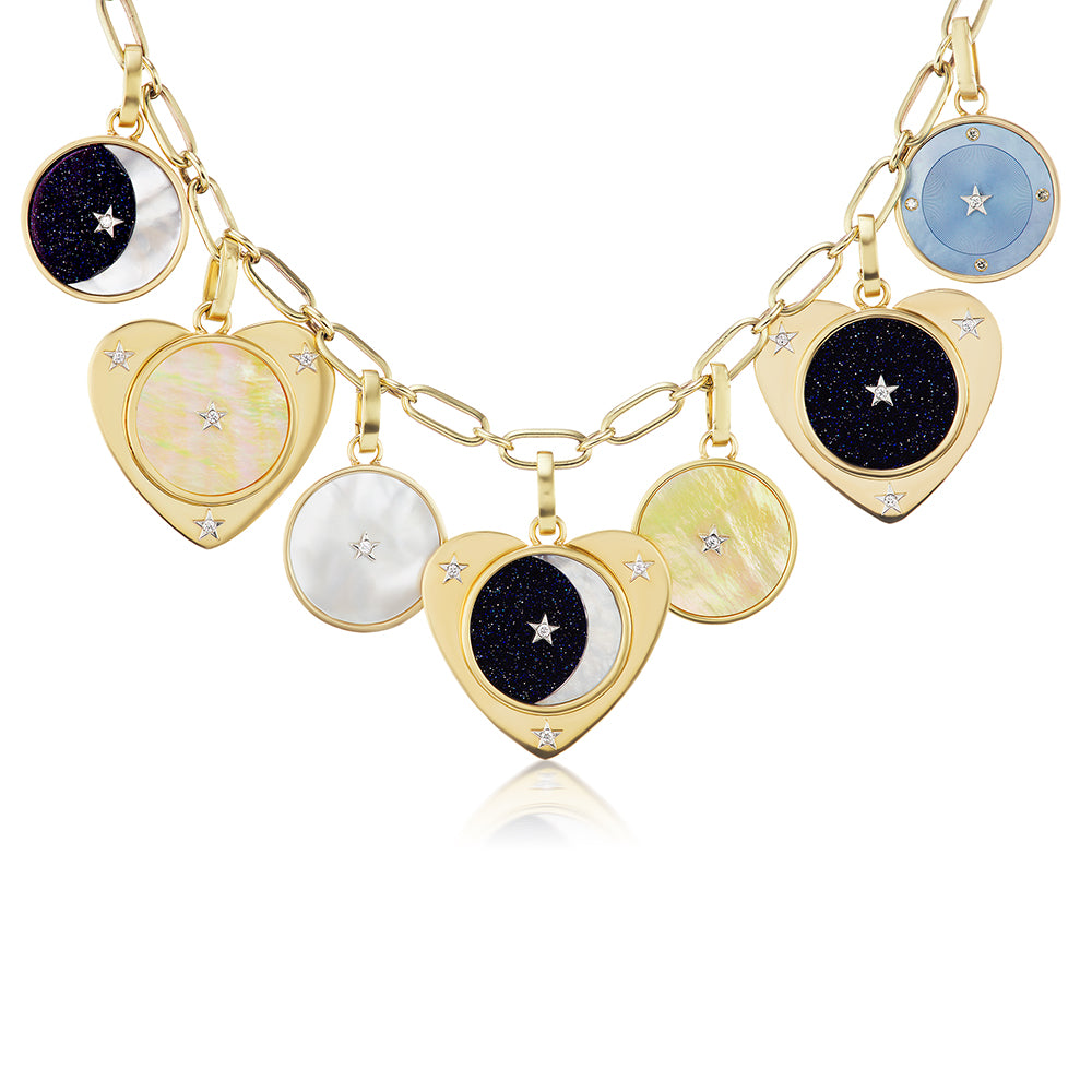 A gold-plated necklace with Anna Maccieri Rossi Mother of Pearl Heart Charm and diamond accented stars and moon charms.