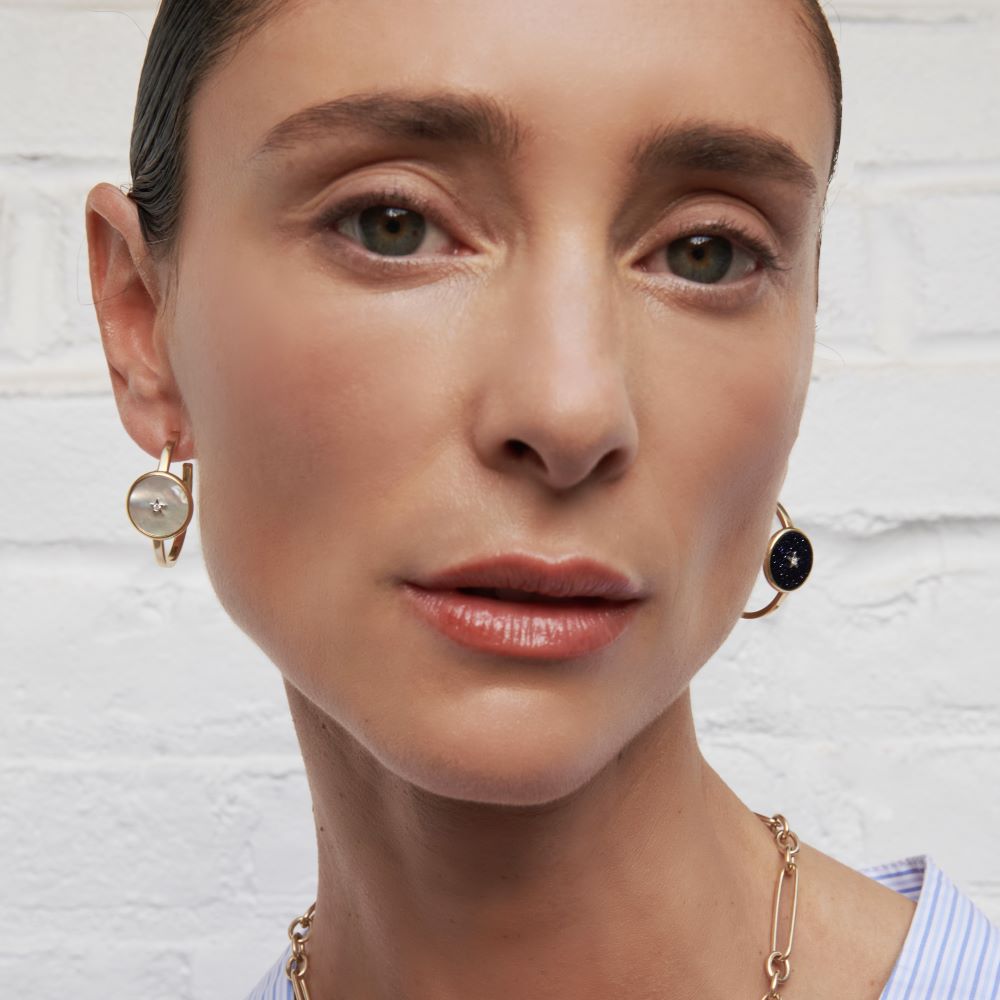 A woman wearing a necklace and Anna Maccieri Rossi Ora Hoop Earrings.