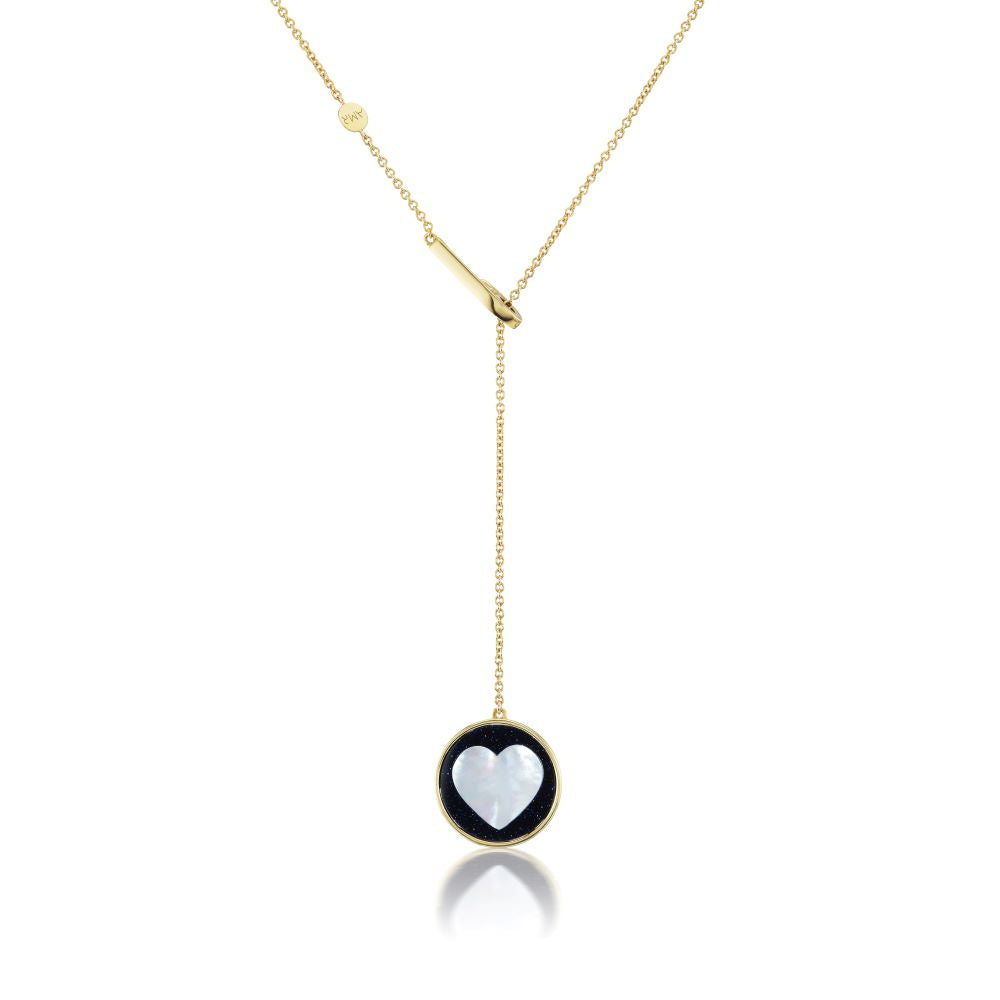 The Ora Midnight In Love Necklace designed by Anna Maccieri Rossi features a gold-plated pendant adorned with an elegant black and white heart.