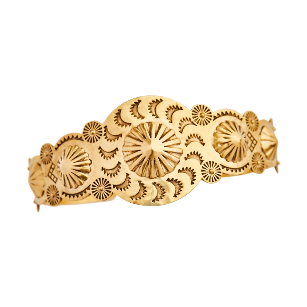 A hammered, yellow gold - plated Christina Alexiou Swirl Cuff bracelet with a sunburst design.