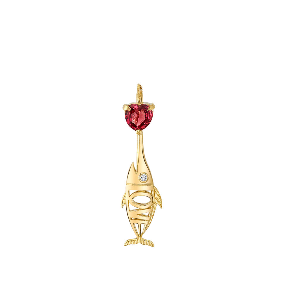 An 18k yellow gold Daniela Villegas Love Fish Charm with a red stone.