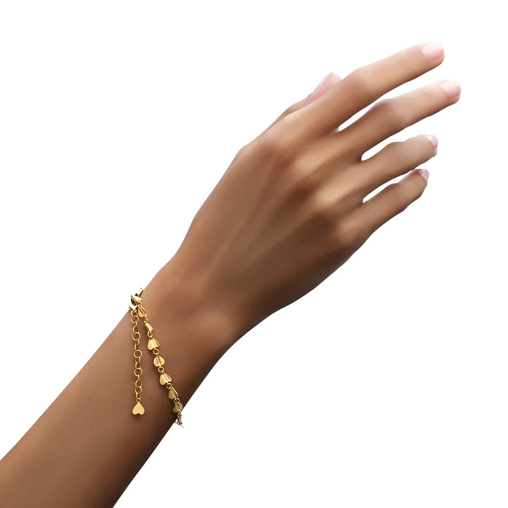 A woman's hand adorned with a folded Cadar Wings of Love Bracelet featuring an adjustable length.