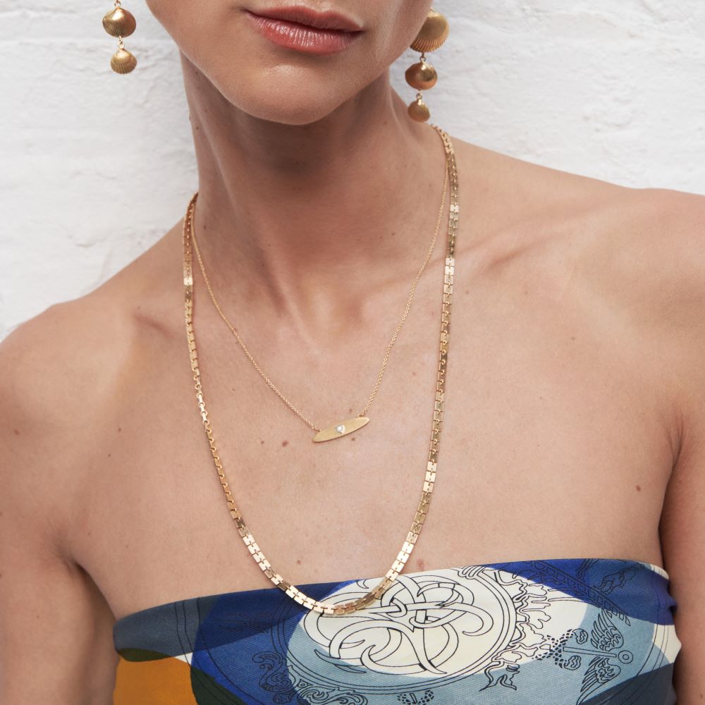 The model is wearing an Anna Maccieri Rossi Silk Plaquette Necklace.