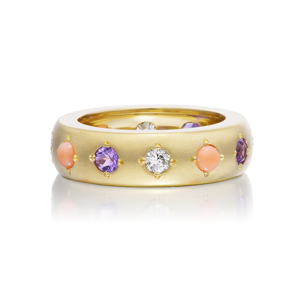 A yellow gold satin finish Gypsy Ring with pink and purple stones by Jenna Blake.