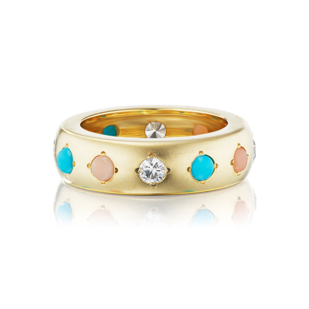 A solid yellow gold Gypsy Ring with inlaid circle cut turquoise stones and diamonds, by Jenna Blake.