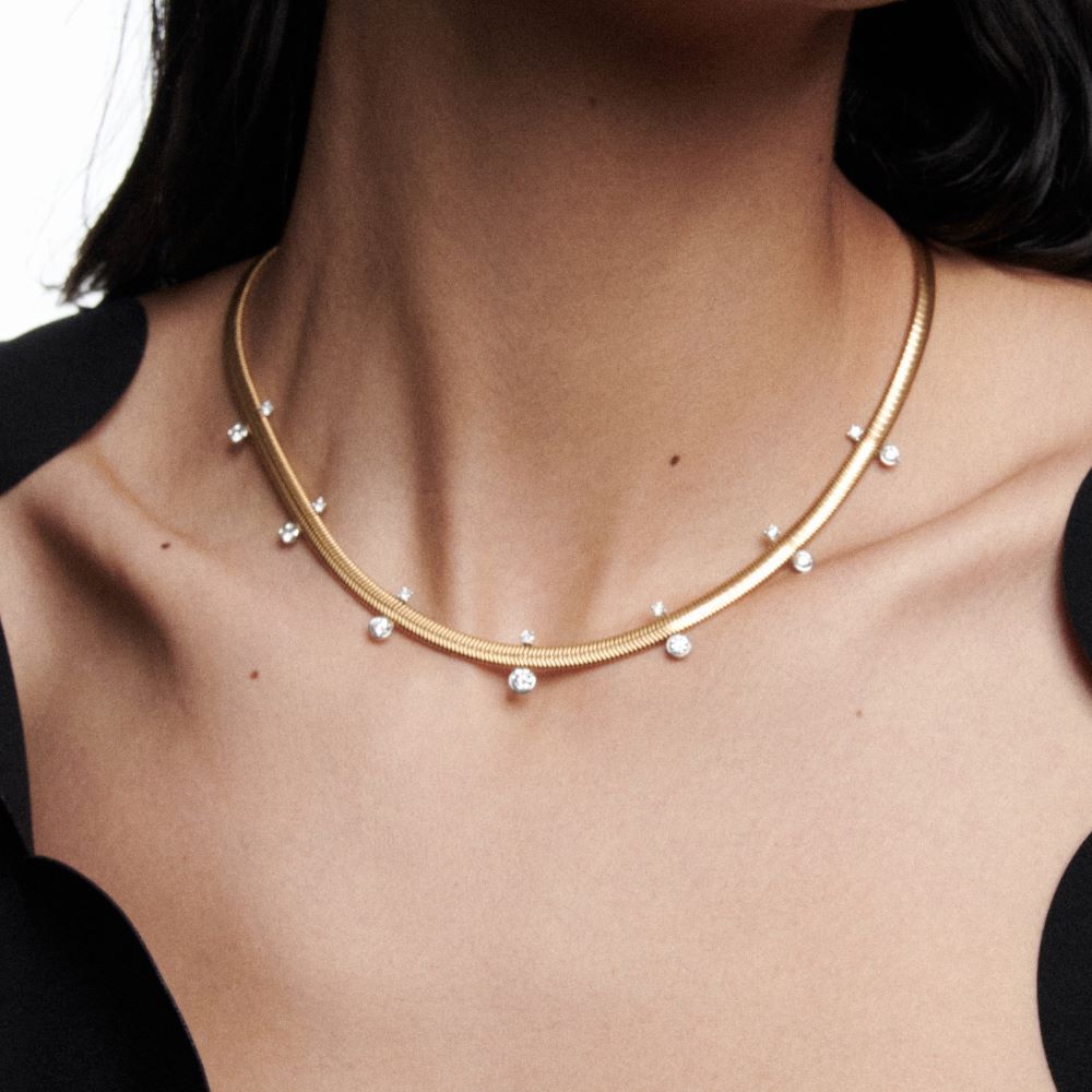 A woman wearing a Nikos Koulis Feelings Diamond Necklace.