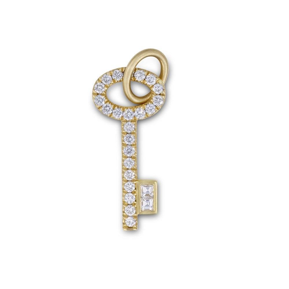 A Michelle Fantaci Amaranthus Key Charm embellished with shimmering white diamonds.