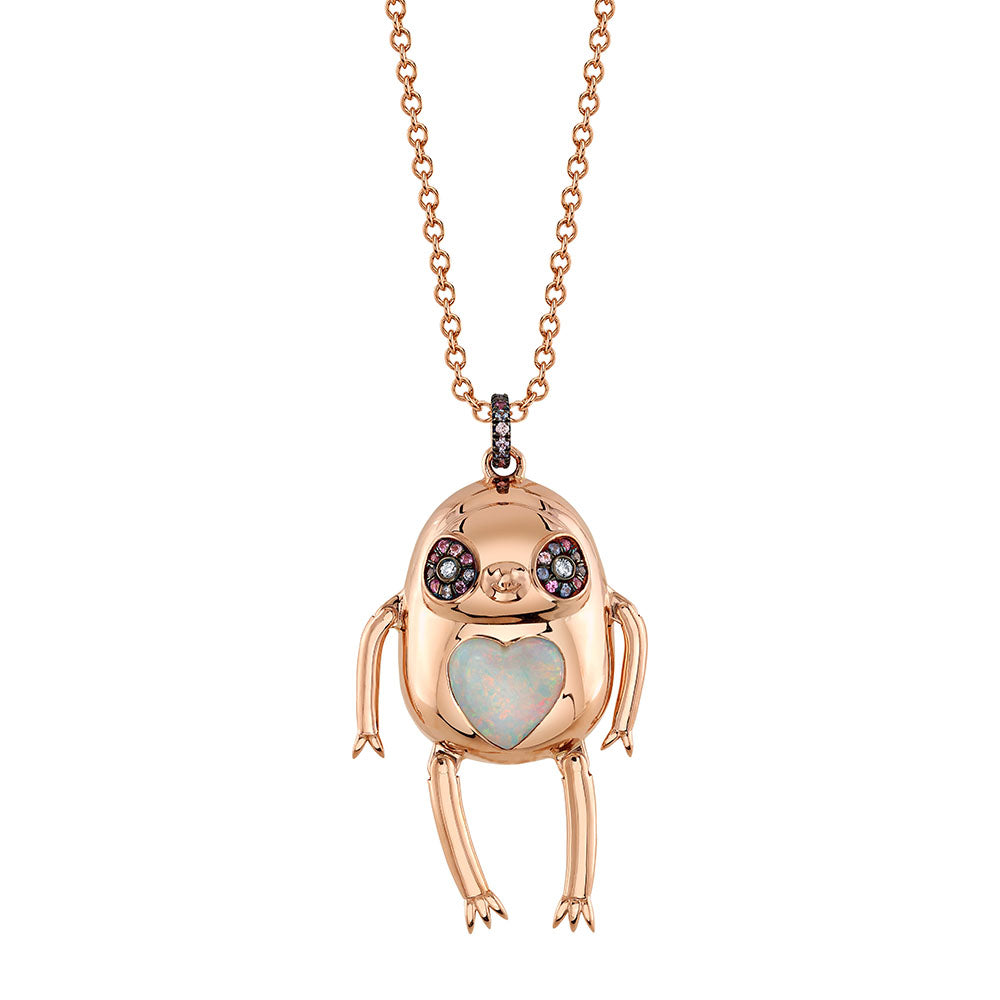A Sloth Magia Pendant Necklace by Daniela Villegas with a rose gold opal heart and a teddy bear on it.
