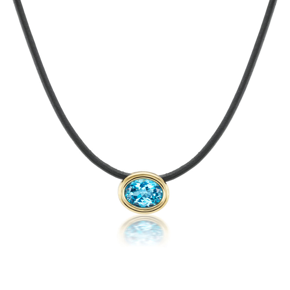 A Beck Scuba Choker Necklace with a blue topaz stone on a leather cord.