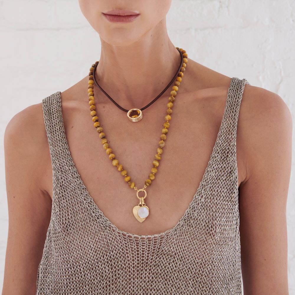 A woman in a grey tank top with a yellow Beck Scuba Choker Necklace.