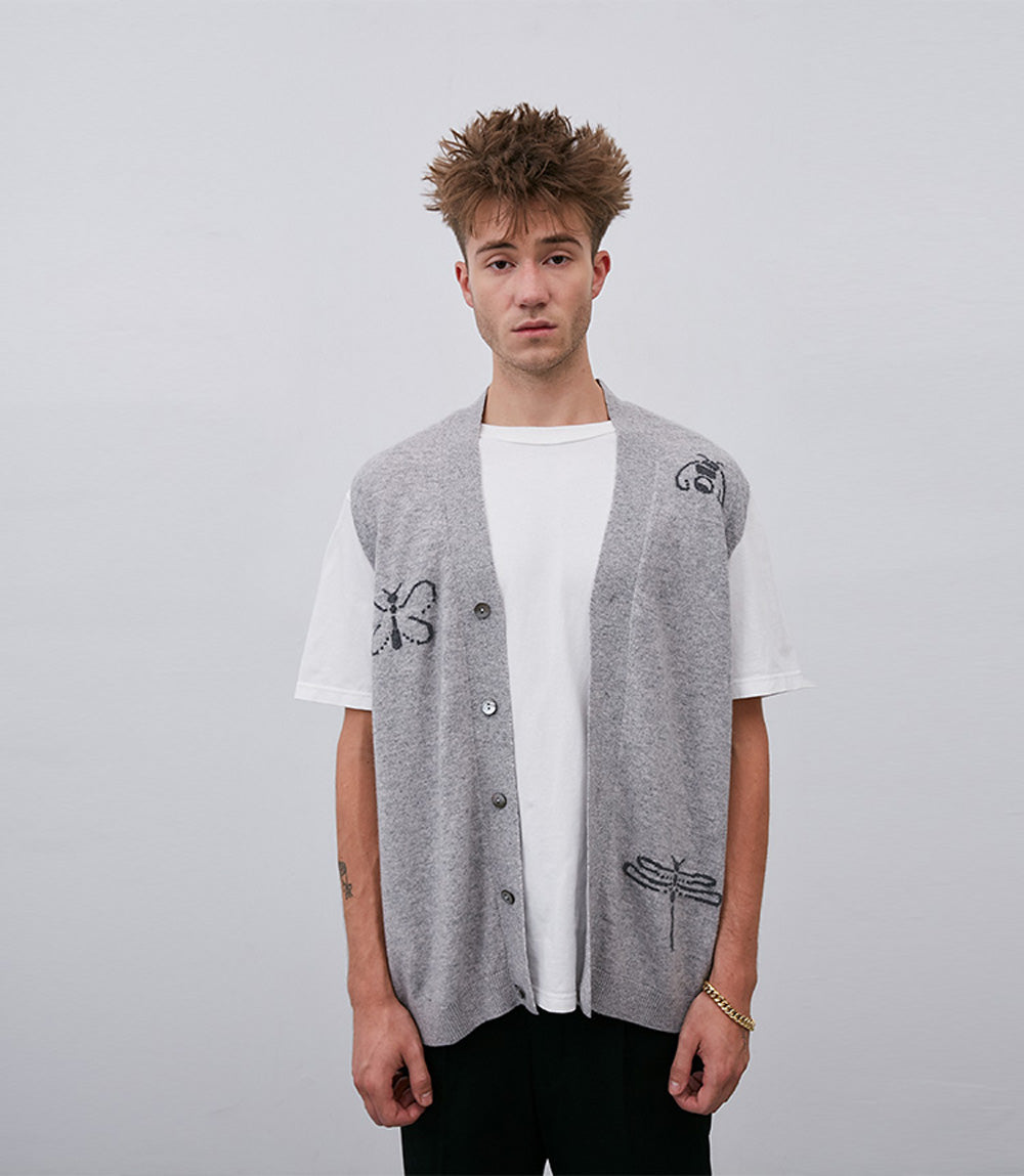 A man wearing a No. 58 Grey Vest, made with Leret Leret's luxurious Mongolian cashmere, and a white t-shirt.