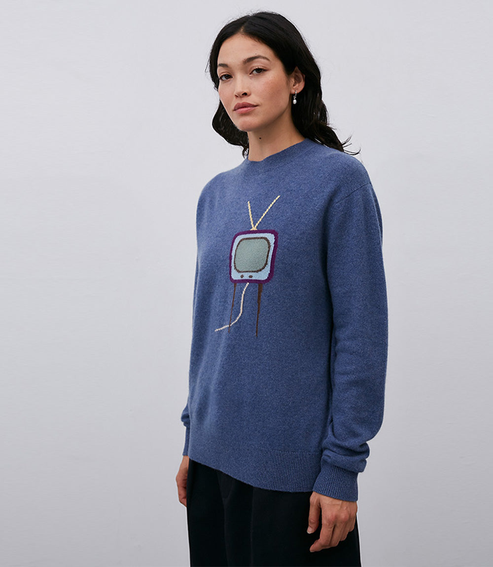 A woman wearing a Leret Leret No. 61 TV Sweater.