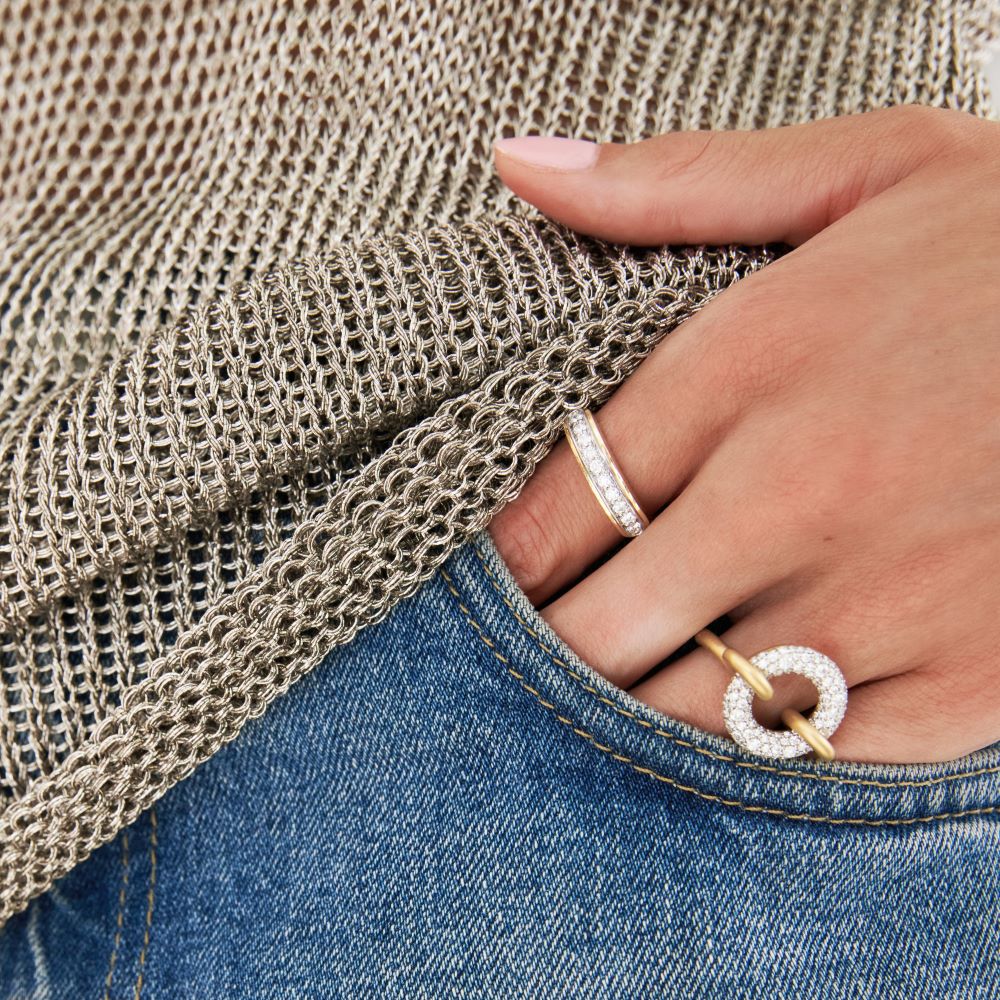 A woman's hand is holding a Beck Mona Diamond Ring in her pocket.