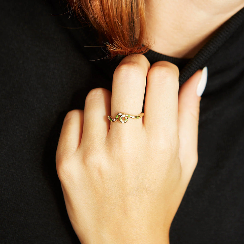 A woman wearing a Bea Bongiasca Wave Ring with a diamond finish.