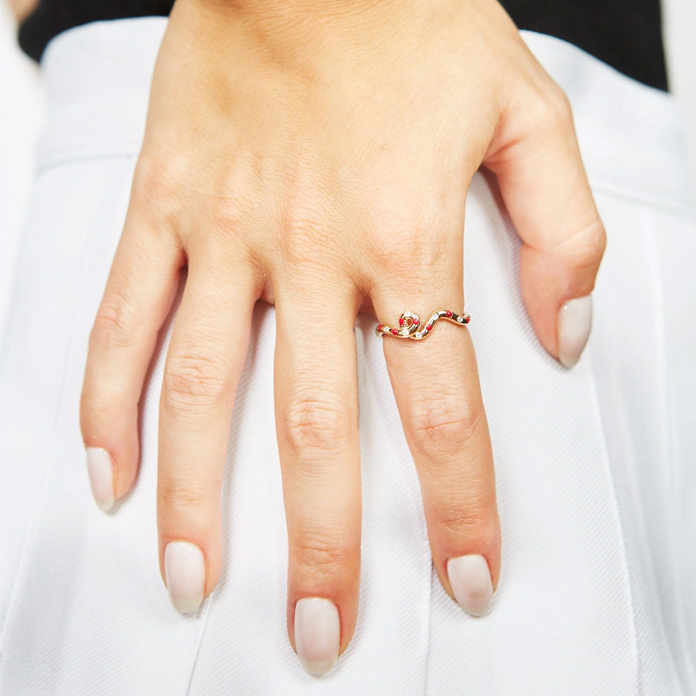 A woman's hand with a Bea Bongiasca Wave Ring adorned with a diamond finish.